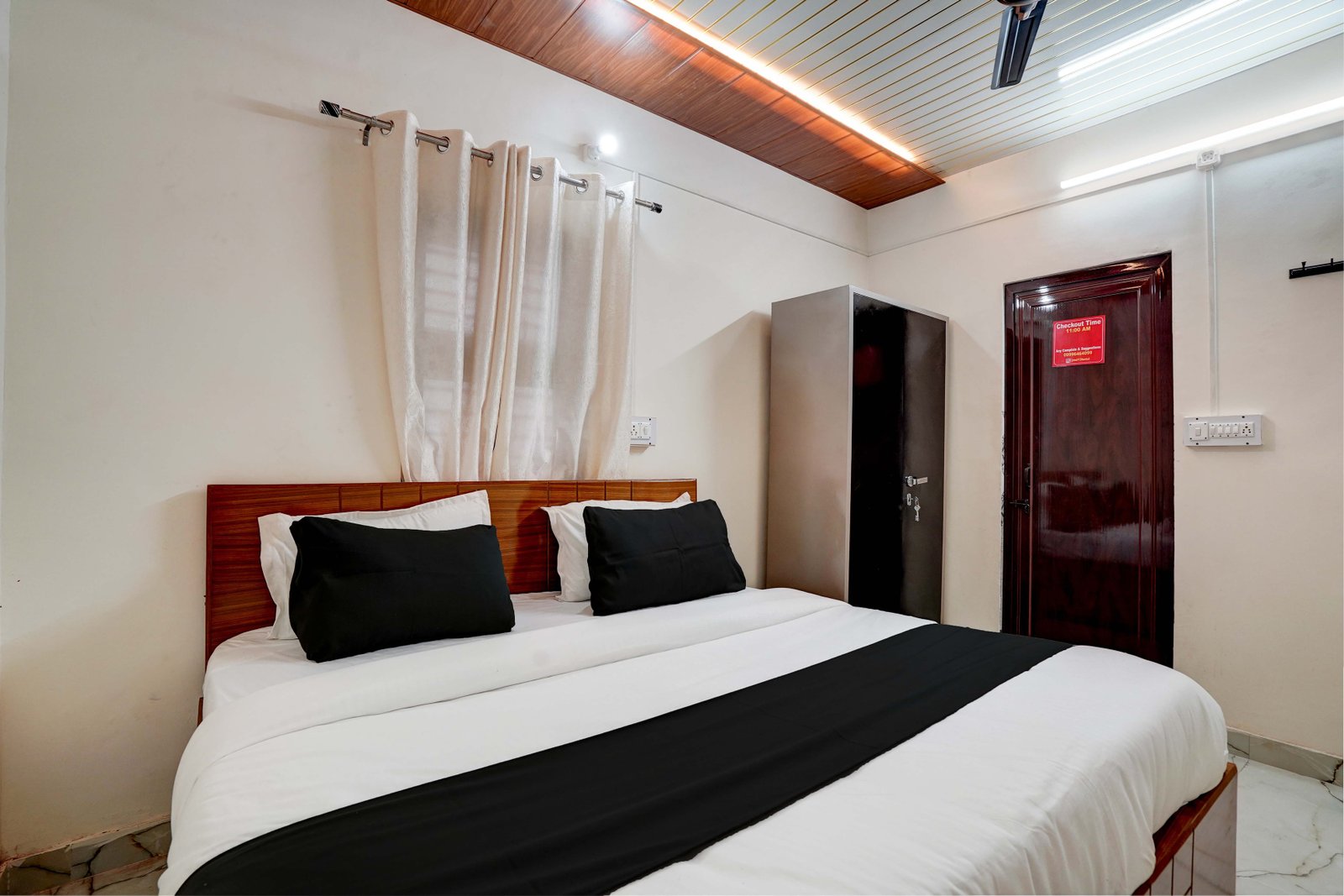JMD 13 Hotel Gurugram Deluxe Bedroom with King Bed and Warm Lighting